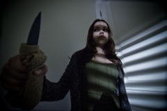 MISCHIEF_NIGHT_EMILY_HOLDING_BROKEN_MIRROR